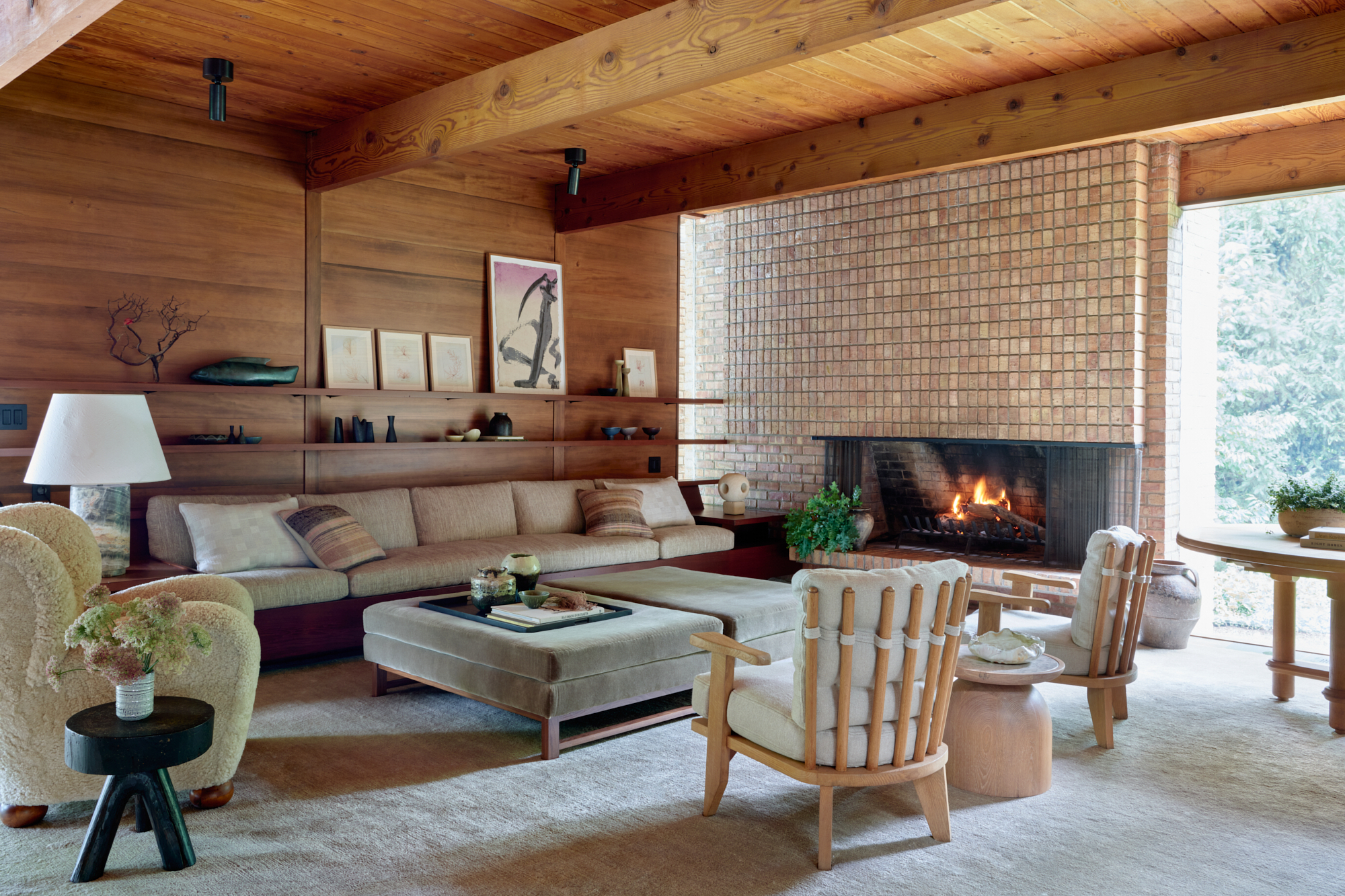 The Great Room in Henry Dubin 'Lakeside Midcentury' home in Michigan by Celeste Robbins, with a fireplace of Chicago brick and vintage Guillerme et Chambron chairs - Effect Magazine