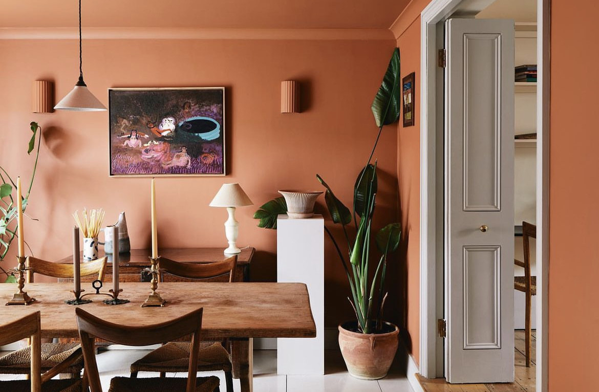 Studio Iro painted a client’s entire living room, including the ceiling, in a Dulux terracotta shade