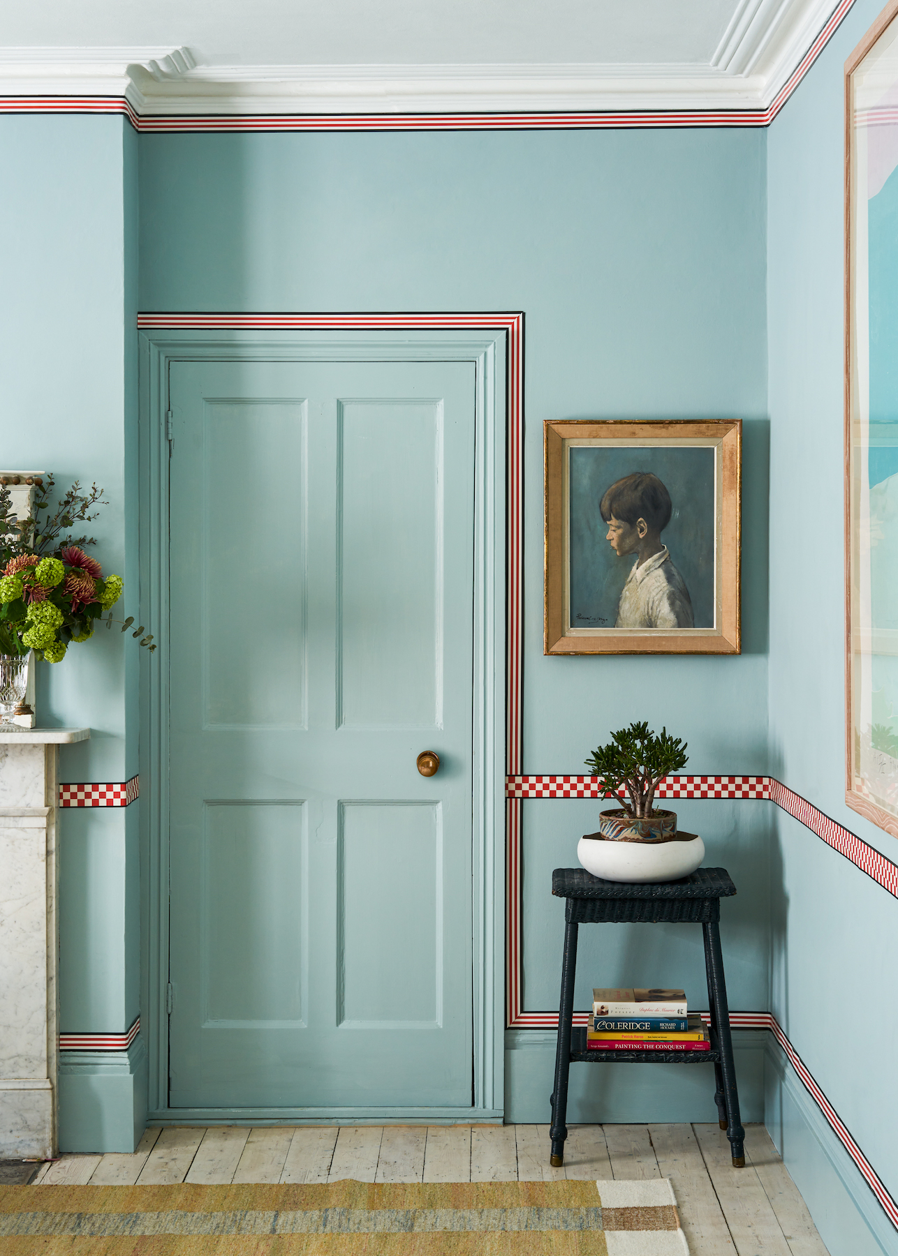 Powder-blue walls are framed in red and navy borders by Studio Atkinson